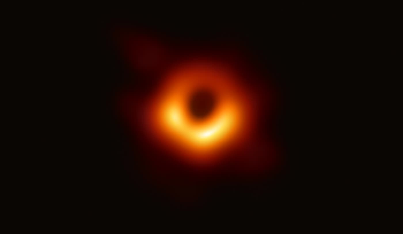 The Event Horizon Telescope image of M87*: a blurred orange ring of light around a dark centre.
