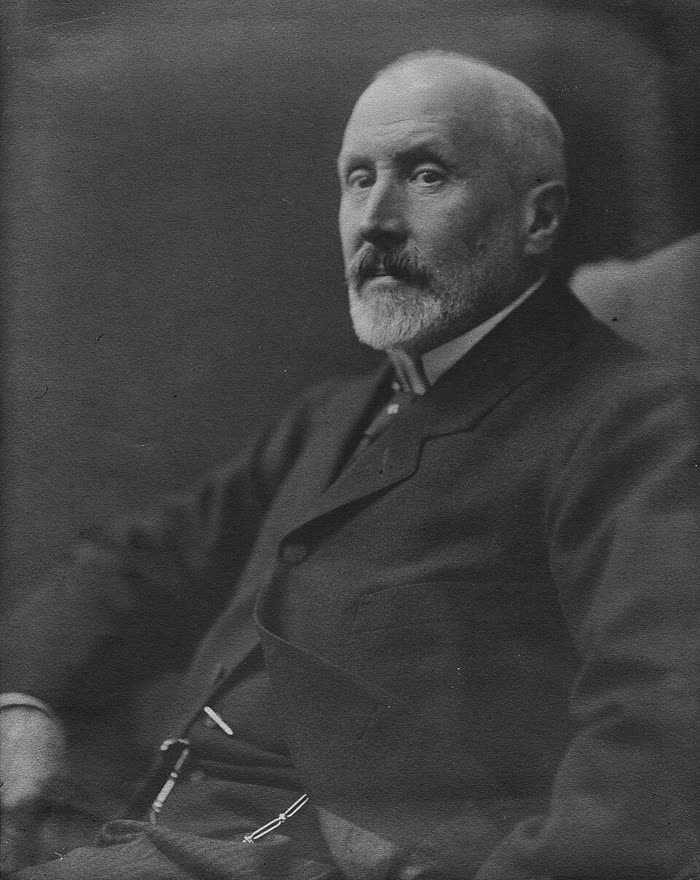 Portrait photograph of Loránd Eötvös, an older man with a full white beard, in formal dress.