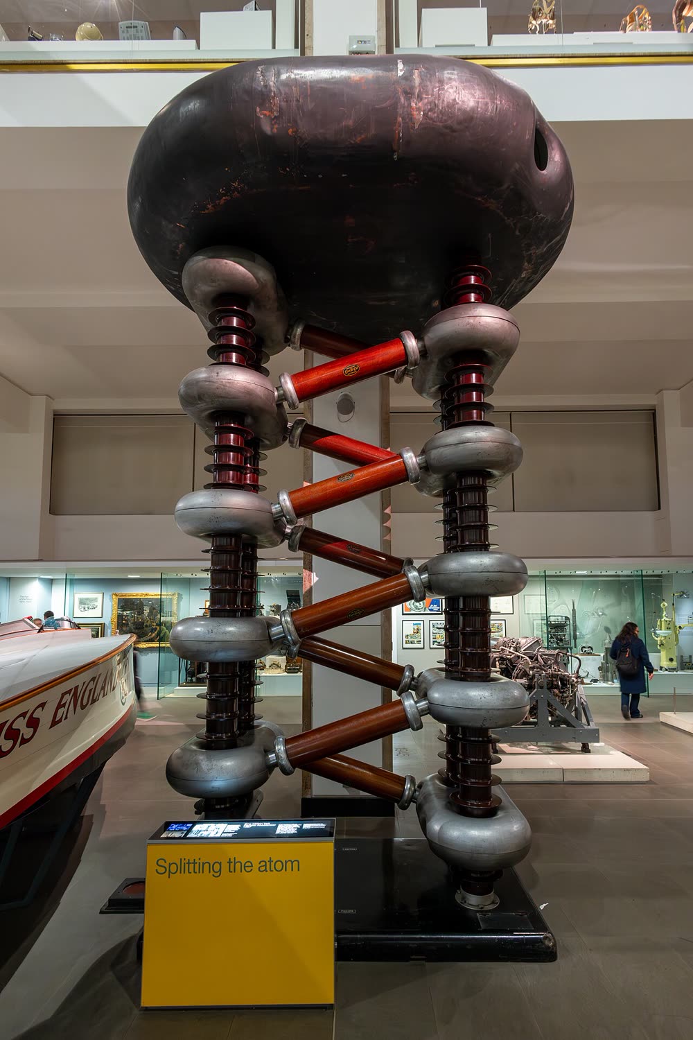 A tall cascade voltage-multiplier accelerator, a stack of large capacitors and rectifiers.