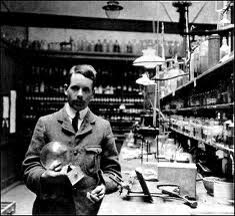 A photograph of Henry Moseley as a young man in academic dress, standing.