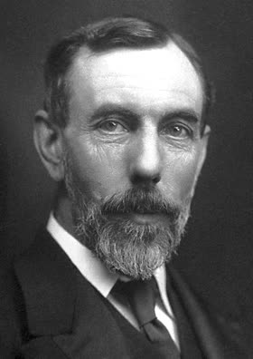 A photographic portrait of William Ramsay, moustached, in a high collar and dark coat.