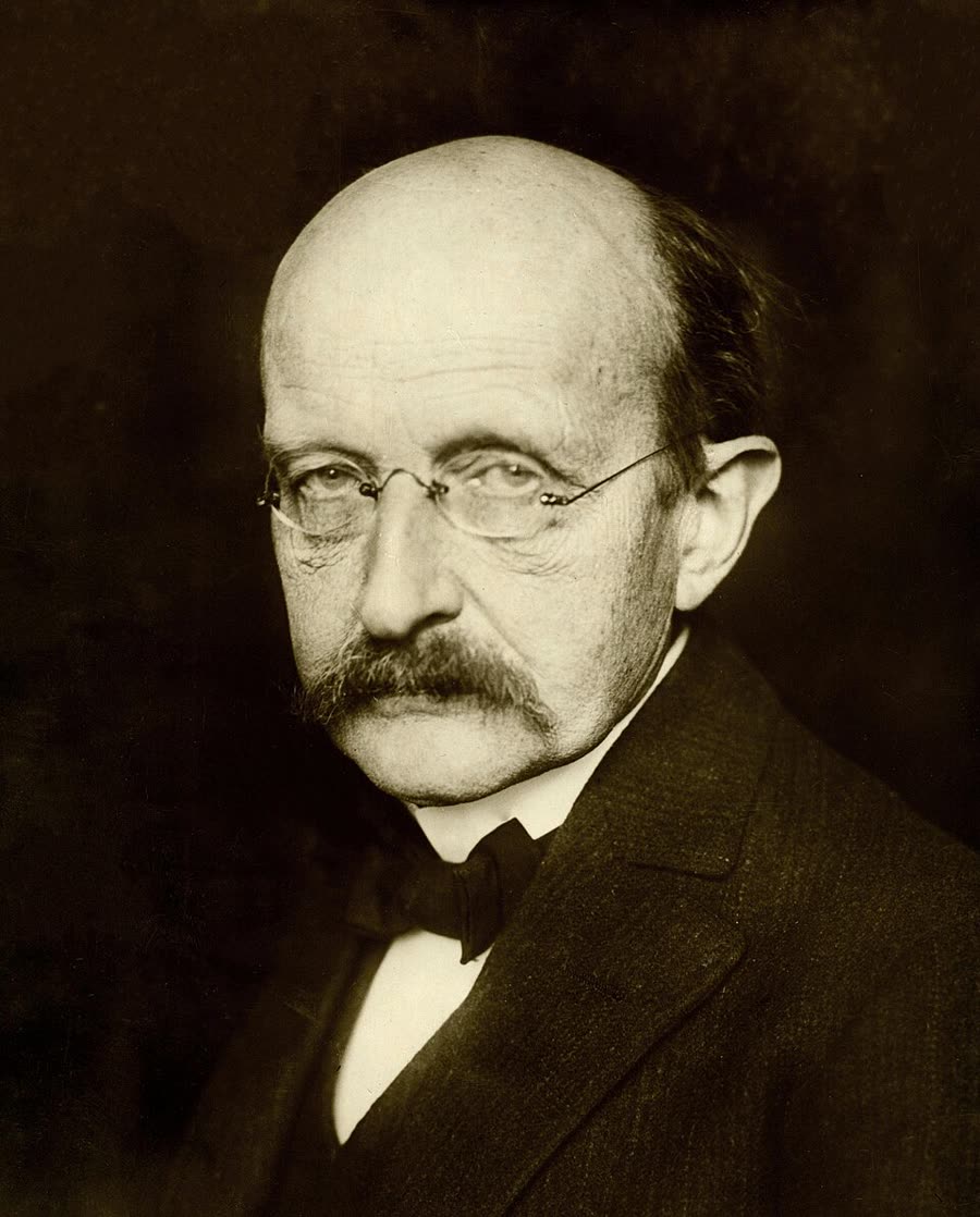 Max Planck in 1933, elderly, in a dark suit and round spectacles.