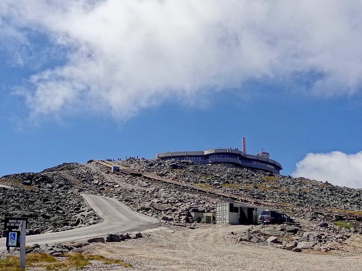 The observatory buildings at the summit of Mount Washington, low stone structures under cloud.