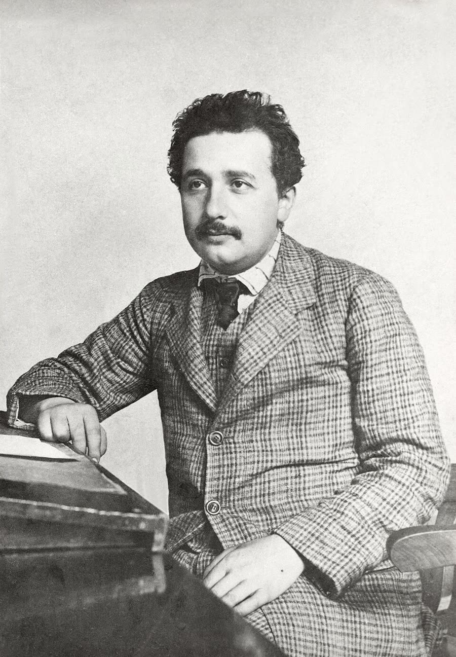 Photographic portrait of Albert Einstein as a young man in 1905, in a suit with a moustache.